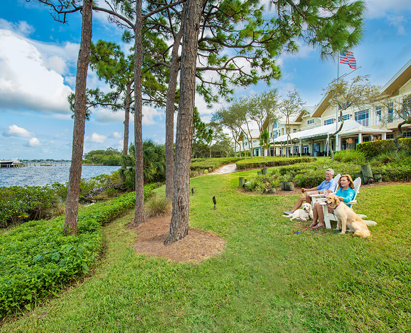 couple in Adirondack chairs with dog