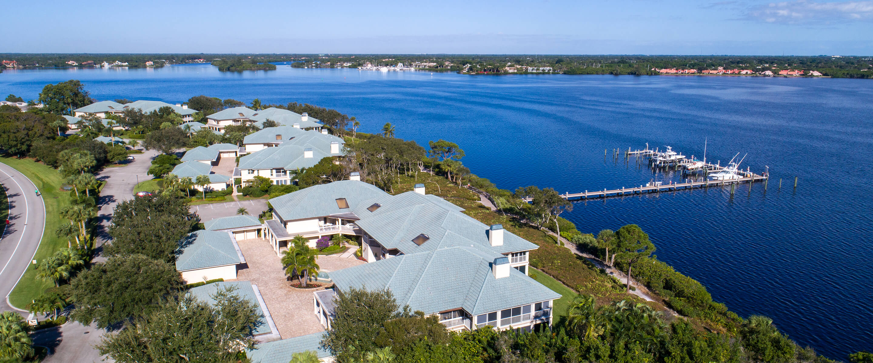 aerial view of homes and dock extending into water