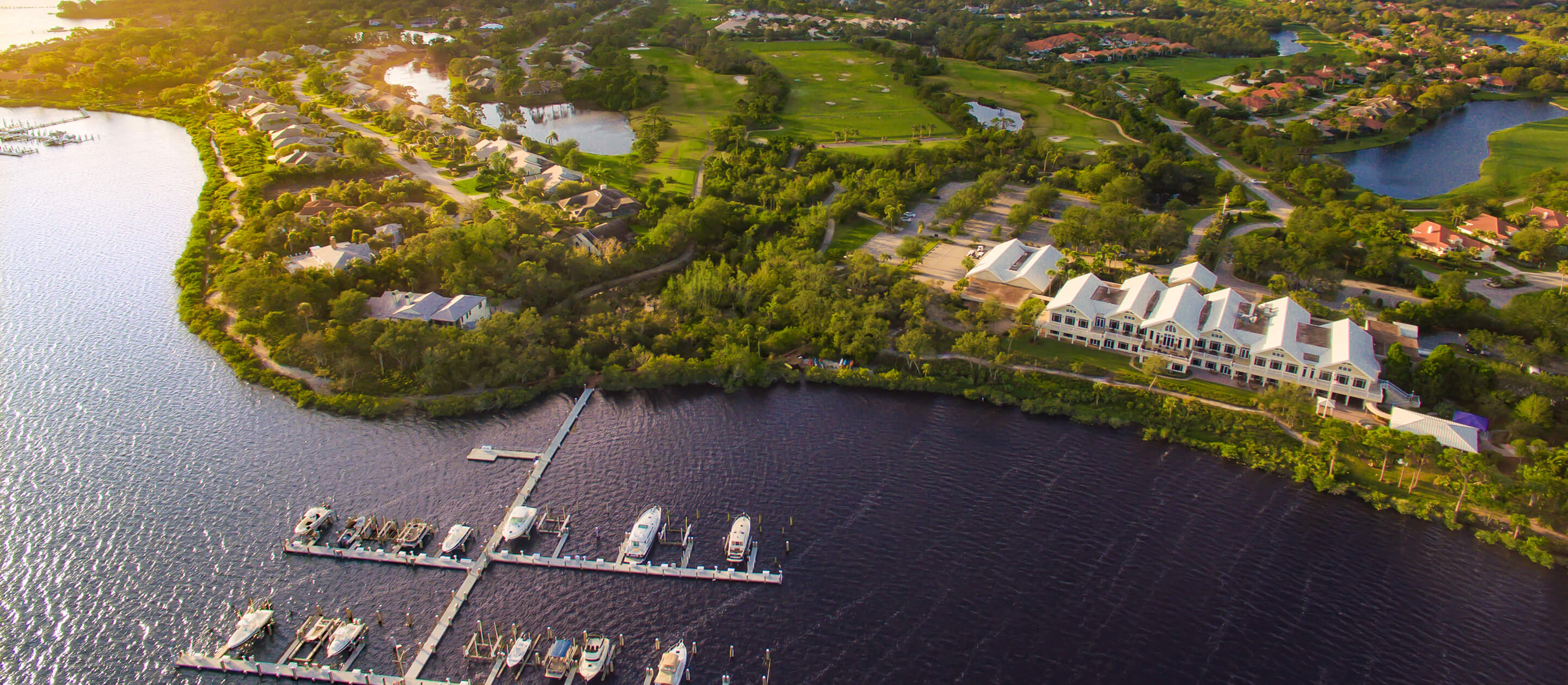 aerial view of club, golf course, and waterway