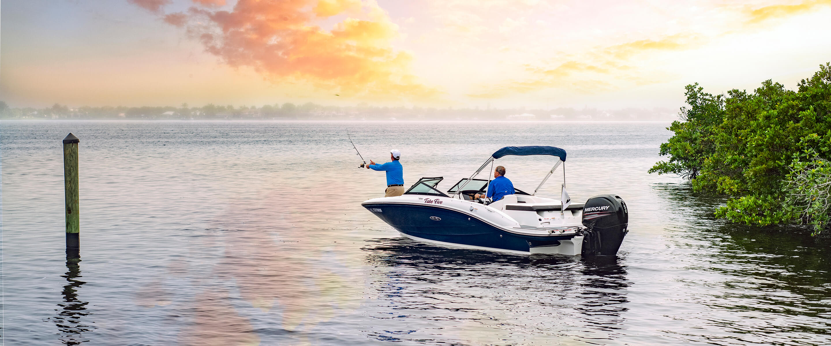 men fishing from boat under colorful sky